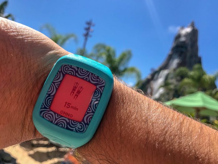 A TapuTapu electronic wristband worn on a visitor's wrist at Volcano Bay